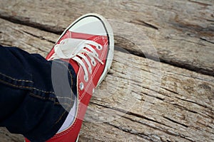 Red shoes on a background of brown wooden photo