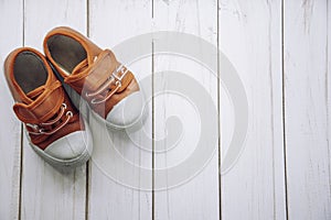 Red shoes for children on wooden floor