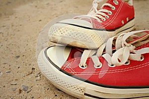 Red shoes on the floor of cement.