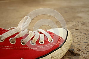 Red shoes on the floor of cement.