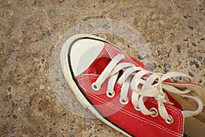 Red shoes on the floor of cement.