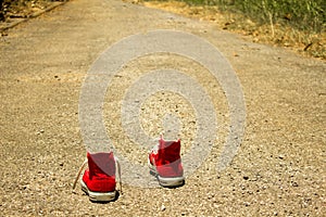 Red shoes are walking on the street moving forward catching bright future on the any ahead opportunity, chances, luck, target, goa