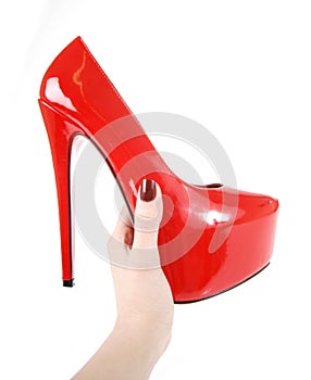 Red shoes in woman hand isolated on white