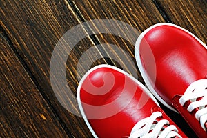 Red shoes on wooden background