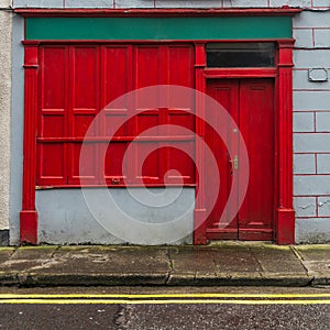 A red shop front in Ireland on a street