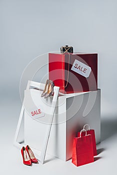 red shopping bags, high heels and sale signs, summer