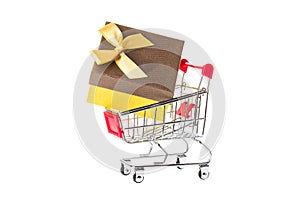 Red shopping cart trolley with a giftbox isolated on white background. Shopping concept.