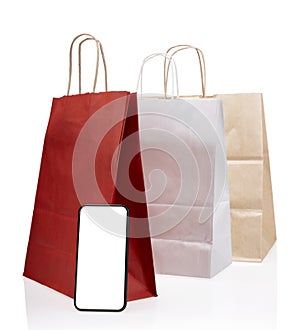 Red shopping online concept with paper bags on smartphone isolated on white