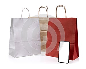 Red shopping online concept with paper bags on smartphone isolated on white