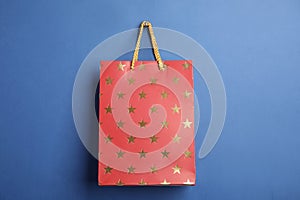 Red shopping paper bag with star pattern on background