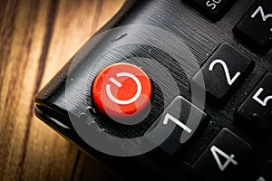 red shut off button on a remote control powering down shutting of concept photo