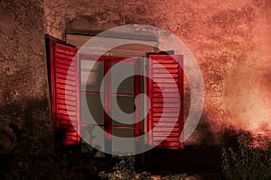 Red shutters at night on Tuscan farmhouse