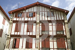 Red shutters in St. Jean de Luz, on the Cote Basque, South West France, a typical fishing village in the French-Basque region near