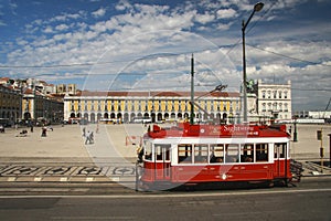 Red sightseeing tram at Lisbon Commerce square