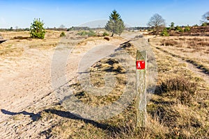 Red sign pointing to the walking direction in Drents Friese Wold National Park