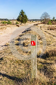 Red sign pointing to the walking direction in Drents Friese Wold National Park