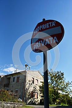Red sign private property in Italy. A house in the background photo