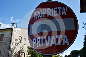 Red sign private property in Italy. A house in the background photo