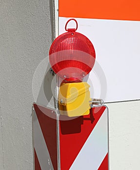 red signal lamp in the corner of the road construction site