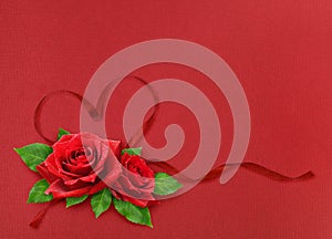 Red silk ribbon hearts and waves with rose flowers on red paper background