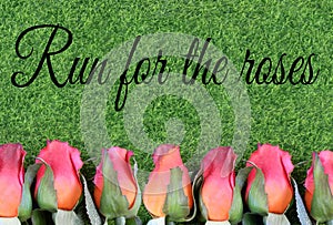 Red silk roses and artificial green grass for the running of the thoroughbred race called the Kentucky Derby.