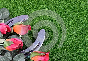 Red silk roses, a horseshoe and artificial green grass for the running of the thoroughbred race called the Kentucky Derby.