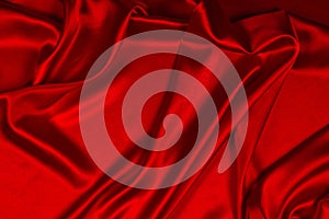 Red silk or satin luxury fabric texture can use as abstract background. Top view