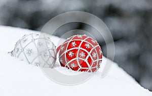 Red and silver Christmas balls on a snowdrift