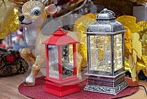 Red and silver christmas lanterns with backlighting against the background of golden leaves
