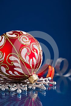 Red and silver christmas ornaments on dark blue background