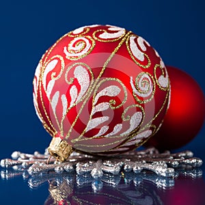 Red and silver christmas ornaments on dark blue background