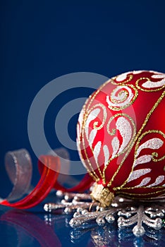 Red and silver christmas ornaments on dark blue background