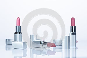 Red and silver lipsticks on white background, .beauty and fashion concept