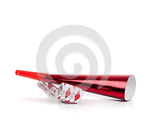 Red and silver noise makers on white