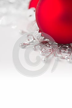 Red and silver xmas ornaments on bright holiday background