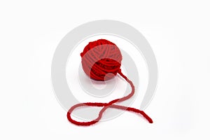 Red skein of thread against white background. Red ball of wool red thread isolated on white