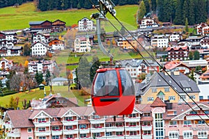 Red ski lift to the Alpe di siusi ski slope from Ortisei ski center in Dolomites