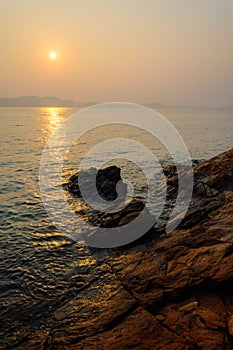 Red sky over a rocky seashore Sunset