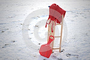 Red Sledge and warm trousers in snow landscape