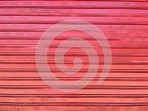 Red sliding metal roll-up door slightly dented. photo