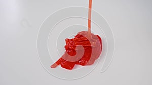 Red slime flowing down on a white background.