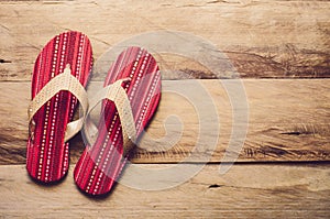 Red slipper on wooden floor