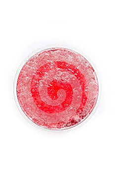 Red slushie in a plastic cup top view