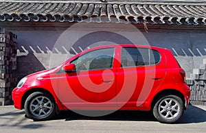 Red small car and wall