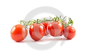 Red small cherry tomatoes on a white background