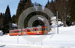 Red small train in Jura mountain