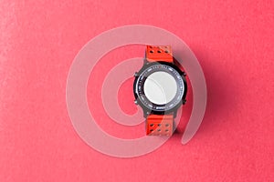 Red smartwatch on red background