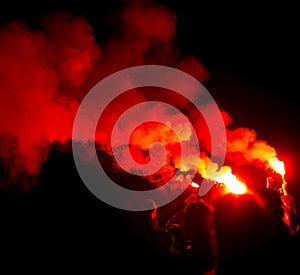 Red smoke from smoke bombs at a concert