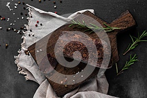 Red smoked dry ham on a wooden cutting board