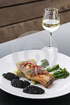 Red snapper fish fillet with vegetables and black rice with black sesame seeds asian modern fusion dish in melbourne australia